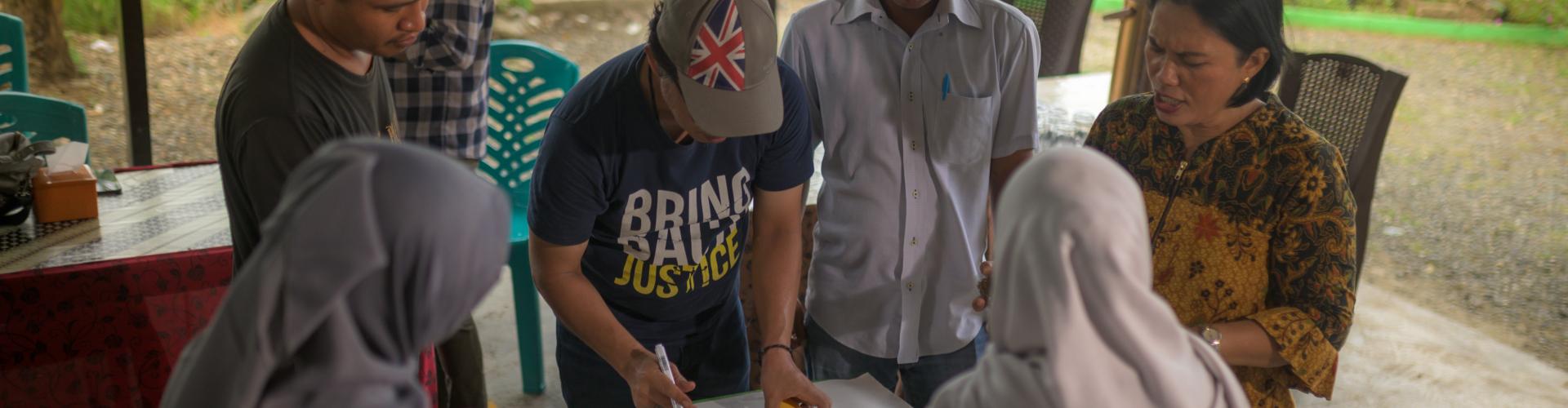 A group of participants gathered around a table in Indonesia