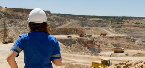 A woman at an open pit mine