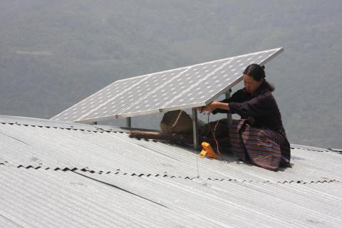A person installing a solar panel