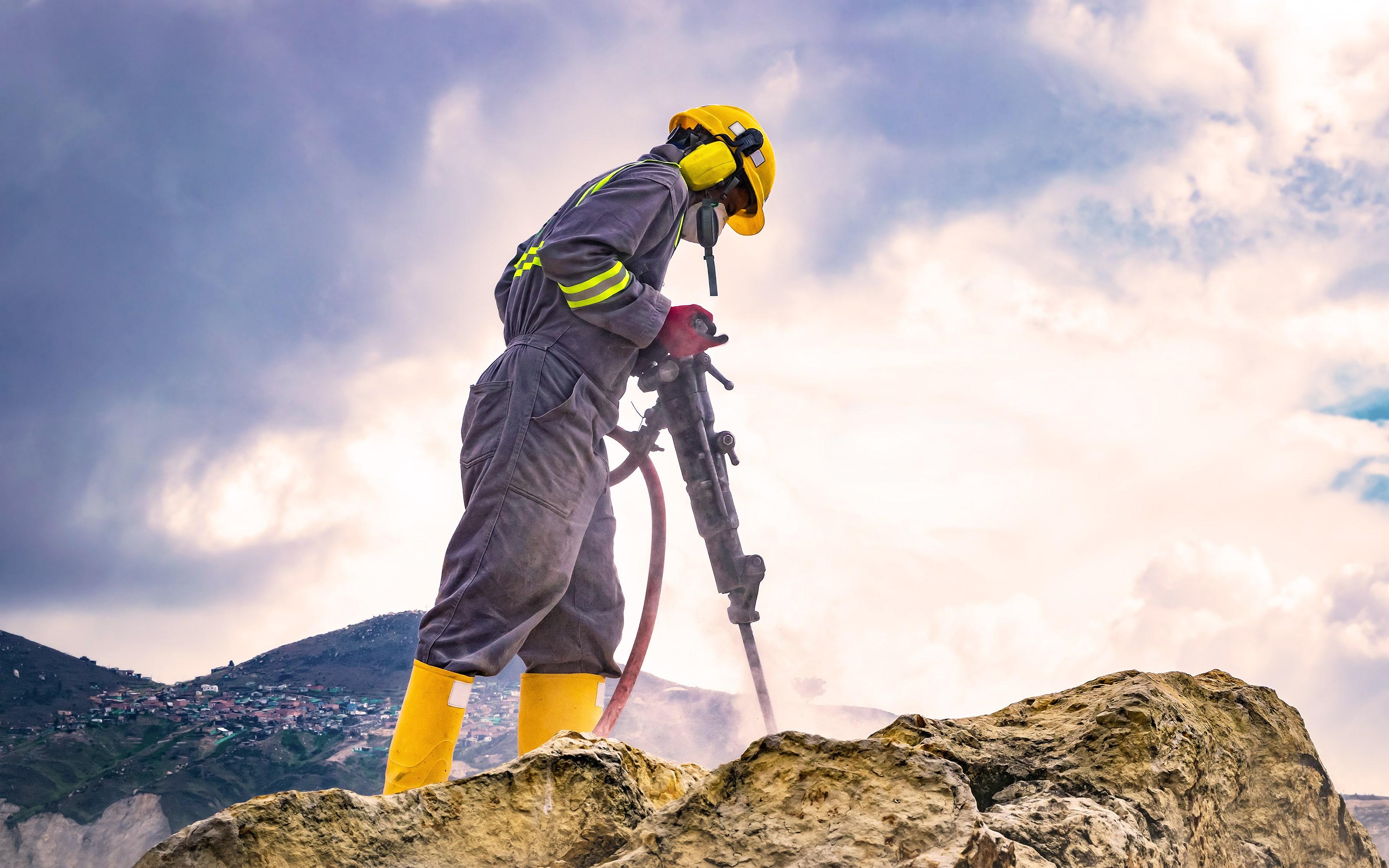 Worker using a drilling machine.